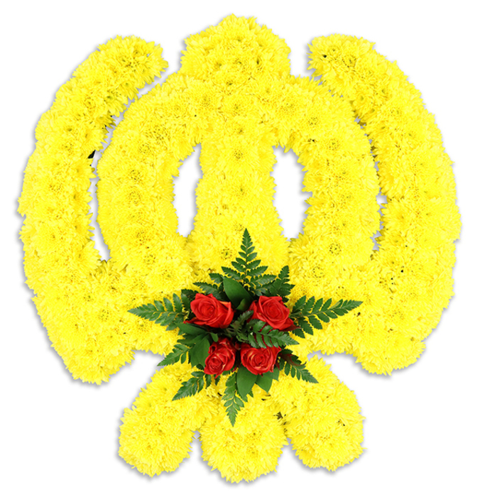 A bold, reverent floral Khanda occupies the frame, its sacred form executed in a continuous field of small, tightly clustered bright yellow chrysanthemum blooms. The design traces every component of the emblem - the round chakram, the central double-edged khanda sword and the two crossed kirpans at the lower section - with precise, textured rows of yellow petals that read as plush, slightly raised relief against the stark white background. At the very heart of the piece, where the circular quoit and the sword intersect, five to six deep crimson roses form a compact focal cluster, their layered petals and velvet finish offering a quiet, dignified contrast. Lush, dark-green fern fronds cradle the roses, their delicate pinnate leaves lending a cool, leafy frame that accentuates the intensity of the red and the warmth of the yellow. A soft grey shadow beneath the tribute anchors it physically and suggests a freestanding memorial display or ceremonial wreath photographed in neutral studio light. The sensory impression is subtle: the honeyed sweetness of chrysanthemum petals, the green, slightly earthy lift from the fern, and the warm, classic perfume of red roses - together creating a composed and respectful atmosphere. Crafted with the care of an experienced local florist, this arrangement would serve gracefully at Sikh remembrance services, cultural commemorations or dignified funerals across Sipson, near Sipson Lane and the Bath Road corridor, embodying both faith and floristry in one thoughtfully assembled piece. Flower Delivery Sipson can replicate this design for local ceremonial needs with attention to tradition and detail.