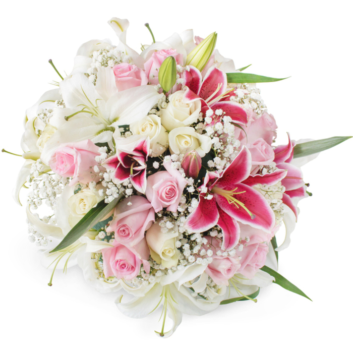 Set against a spotless white background, this meticulously crafted round bouquet showcases the skill of an experienced Sipson florist, combining classic romance with a touch of drama. The central focus is a generous cluster of white lilies, their elongated petals gracefully arching back to reveal pale green centers and neatly formed stamens dusted with soft pollen. These lilies seem to float among an abundance of roses in harmonising tones of blush pink and creamy ivory, each rose carefully nestled so that their petal swirls create a continuous tapestry of velvety texture. Some rosebuds remain serenely closed, promising future bloom, while others are open wide, displaying every delicate curve. Interwoven through this pastel landscape are dazzling magenta and fuchsia Oriental lilies, their star-shaped petals edged in lighter pink and speckled with deeper tones that draw the eye into the heart of the arrangement. To soften the transitions between these bold focal flowers, a fine mist of white baby's breath is scattered throughout, its tiny blossoms forming a lace-like veil around the larger blooms. Slim green leaves and hints of lily buds break the surface here and there, adding a refreshing contrast of colour and suggesting natural movement. The evenly lit, shadow-free setting highlights every nuance of texture, from the satin sheen of rose petals to the slightly waxy lily leaves, making the bouquet appear freshly picked and artfully gathered. This design would sit beautifully in a Sipson living room overlooking local green spaces or on a welcoming reception desk along Sipson Road, evoking feelings of joy, tenderness, and thoughtful celebration for anniversaries, engagements, or heartfelt thank-you gestures.